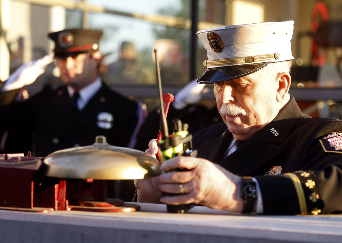 Former Las Vegas Fire and Rescue Spokesperson Tim Szymanski performs the tolling of the bell du ...