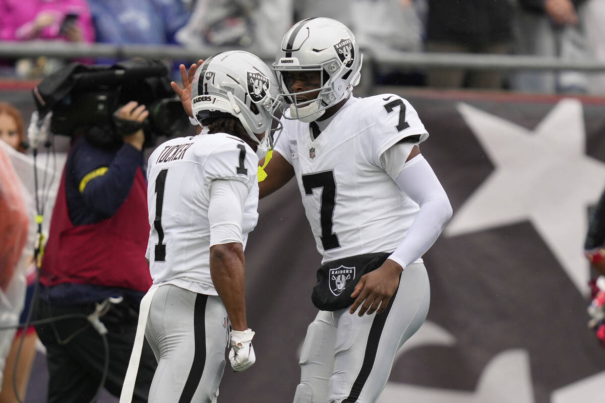Las Vegas Raiders quarterback Geno Smith (7) celebrates after Las Vegas Raiders wide receiver T ...