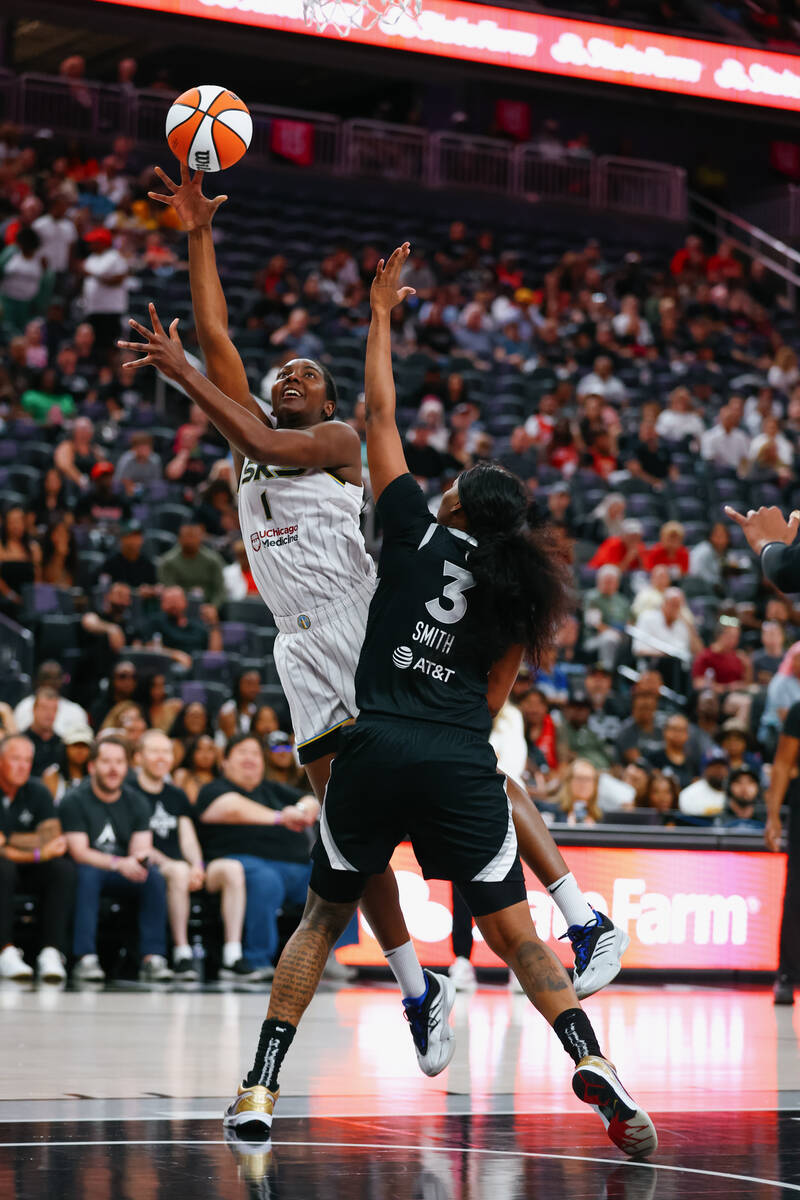 Chicago Sky center Elizabeth Williams (1) makes a layup as Aces forward NaLyssa Smith (3) defen ...
