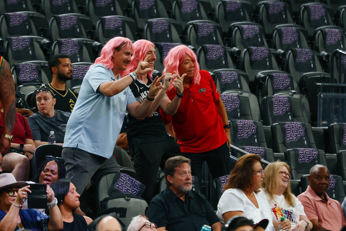 Fans wearing pink wigs pose for a photo before the Aces’ last home game of the regular s ...