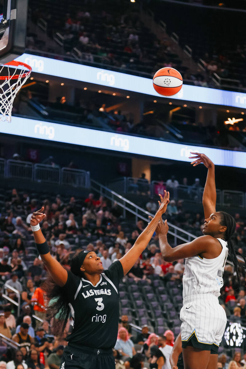 Chicago Sky center Elizabeth Williams (1) tries to make a shot over Aces forward NaLyssa Smith ...