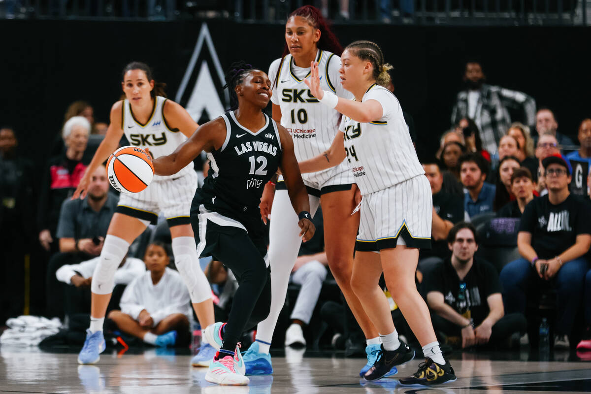 Aces guard Chelsea Gray (12) tries to find someone to pass to as she maneuvers around Chicago S ...
