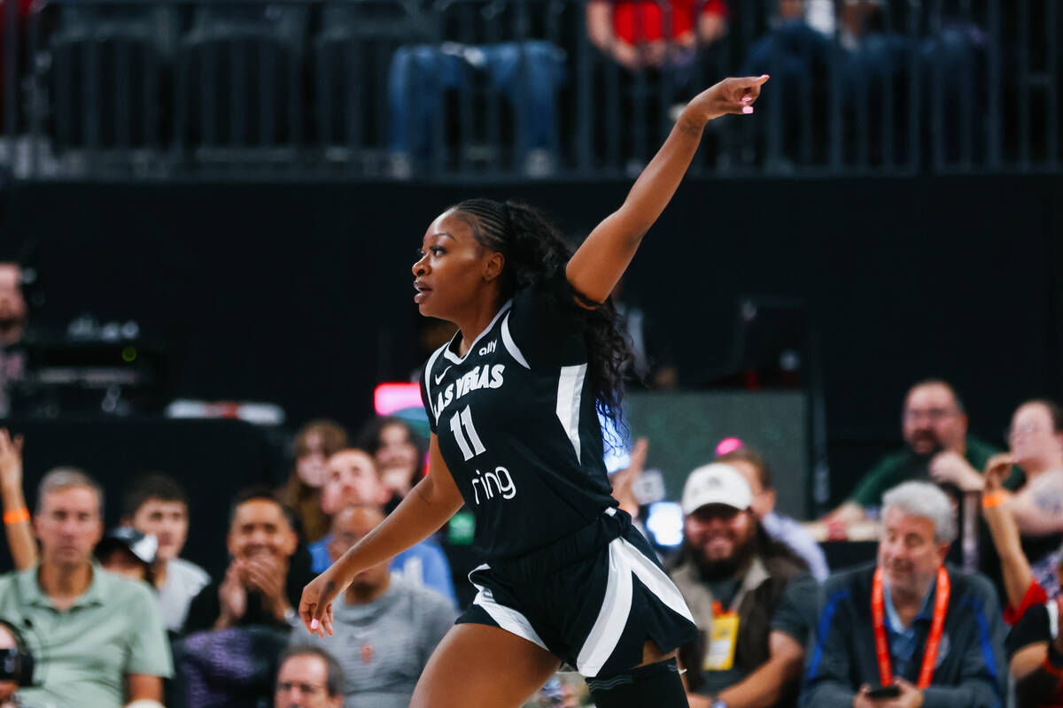 Aces guard Dana Evans (11) celebrates a three-pointer during the first half of the Aces’ ...