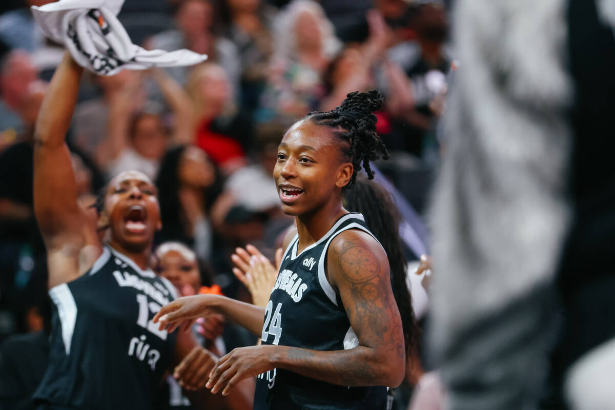 The Aces bench cheers as Aces guard Jewell Loyd (24), center, reaches the 6,000 career point mi ...