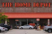 A shopper leaves a Home Depot store, Thursday, Aug. 14, 2025, in Manchester, N.H. (AP Photo/Cha ...