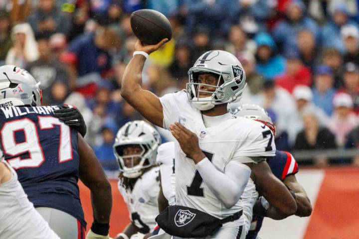 Raiders quarterback Geno Smith (7) makes a throw with New England Patriots defensive end Milton ...