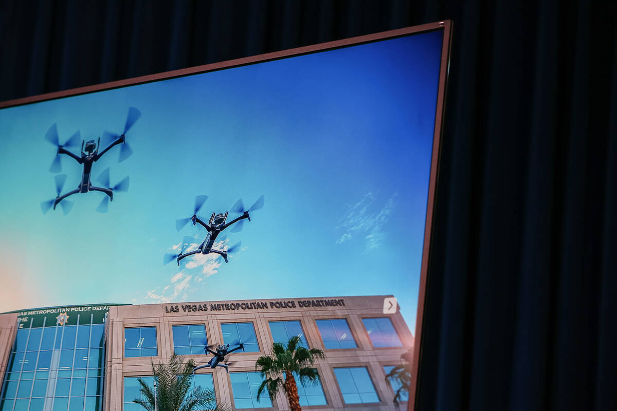 Drones fly through the air outside headquarters, as shown on a screen during a briefing about t ...