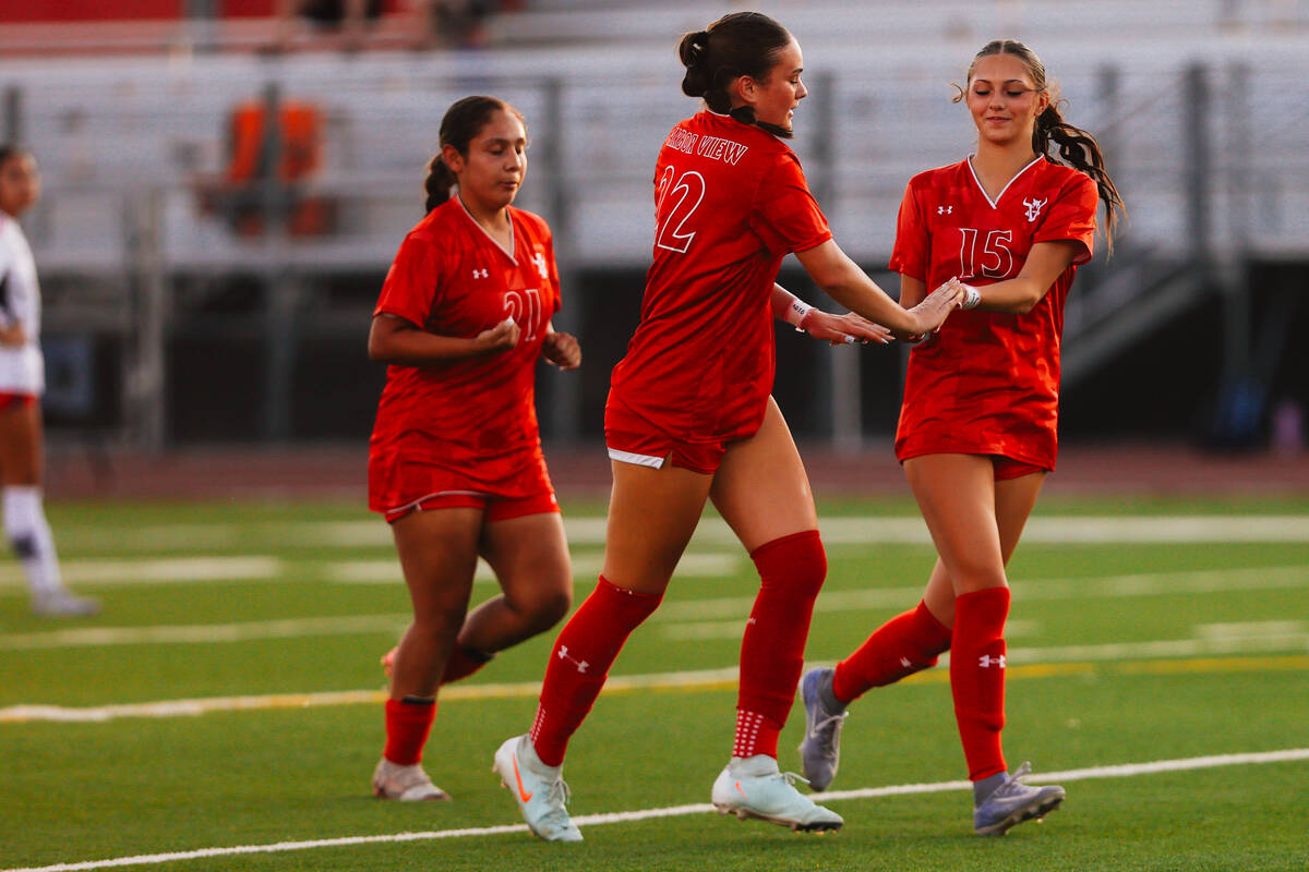 Arbor View teammates Sydney Smith (22) and Cadence Atkins (15) celebrate a goal during a girls ...