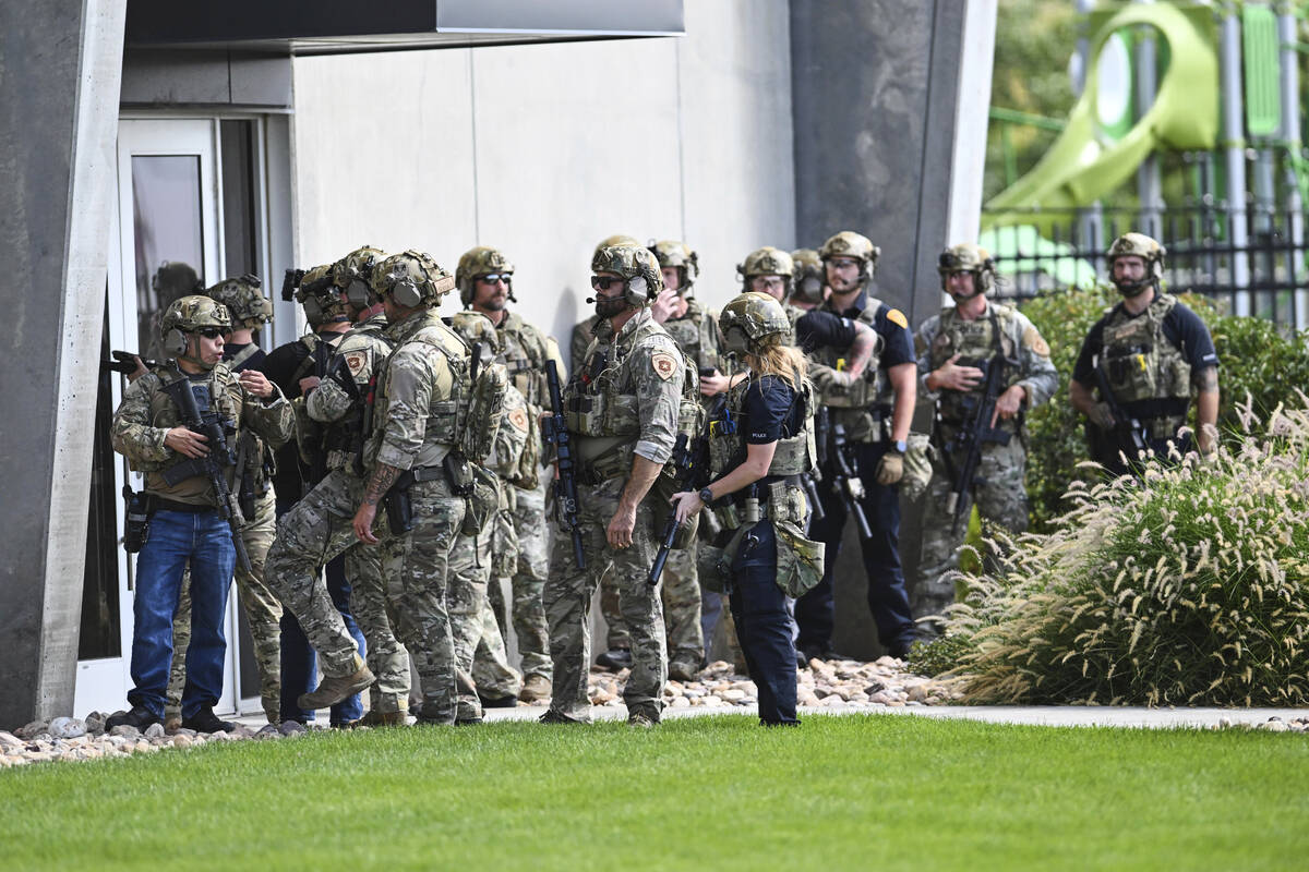 Law enforcement officials prepare to sweep a building at Utah Valley University, Wednesday, Sep ...