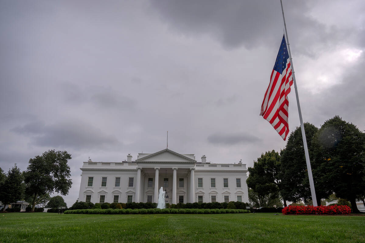 The American flag on the North Lawn at the White House in Washington, is lowered to half-staff ...