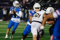 Bishop Gorman quarterback Maika Eugenio looks to throw the ball during a high school football g ...