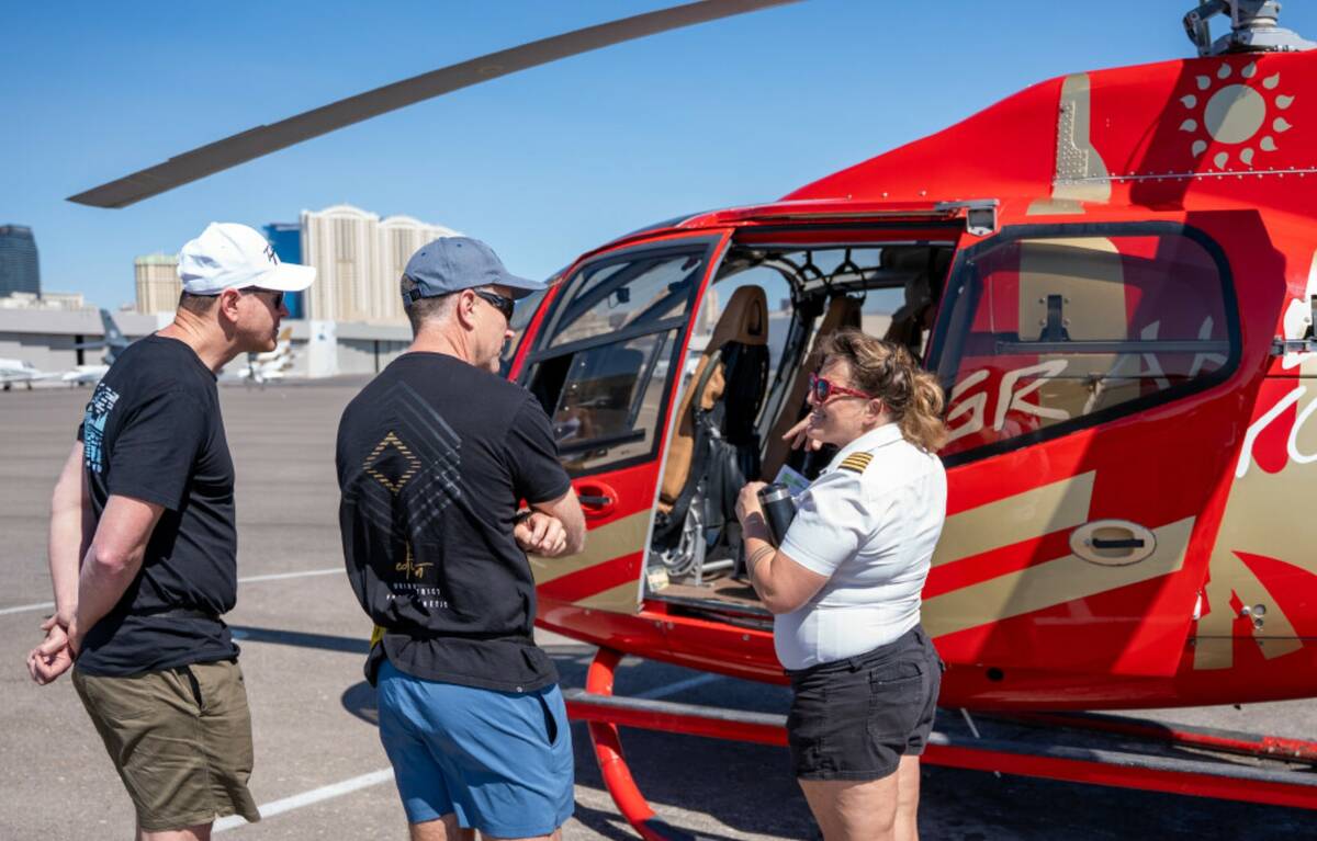 Lead helicopter pilot Allison “Ali” Mohring gives a safety briefing to passengers from the ...