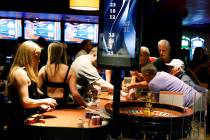 Guests place bets on a roulette table during the final night of dancing dealers and live table ...