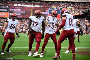 Washington Commanders tight end Zach Ertz (86) celebrating his touchdown with quarterback Jayde ...