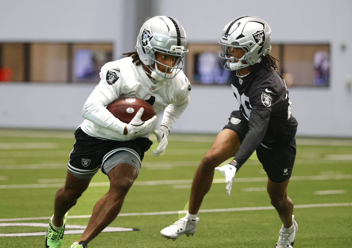 Raiders wide receiver Tre Tucker (1) runs past cornerback Darien Porter (26) during team practi ...