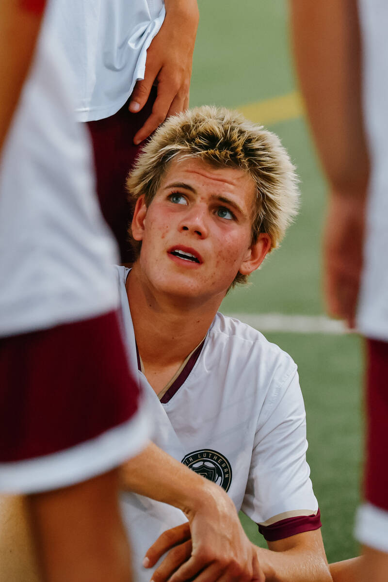 Faith Lutheran forward Tohotom Hajdu (17) sits with his team during halftime of the soccer game ...