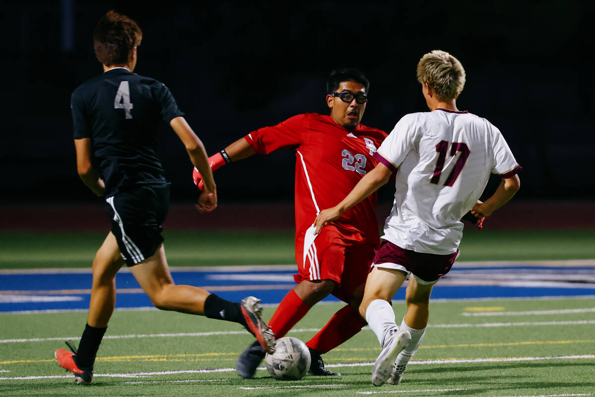 Desert Pines goalkeeper Ulises Huerta (22) runs up to kick the ball away from Faith Lutheran fo ...