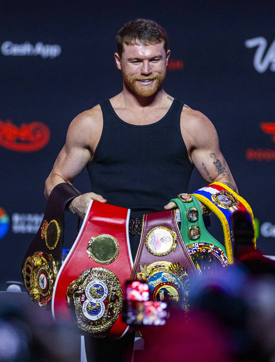 Saul ‘Canelo’ Alvarez holds his collection of belts following his press conferenc ...