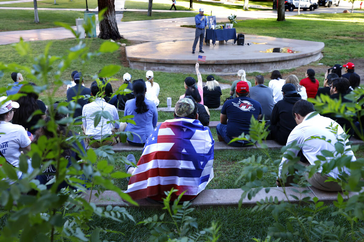 UNLV student Yisrael Ban Abraham wrapped in both Israeli and U.S. flags attends a Vigil in hono ...