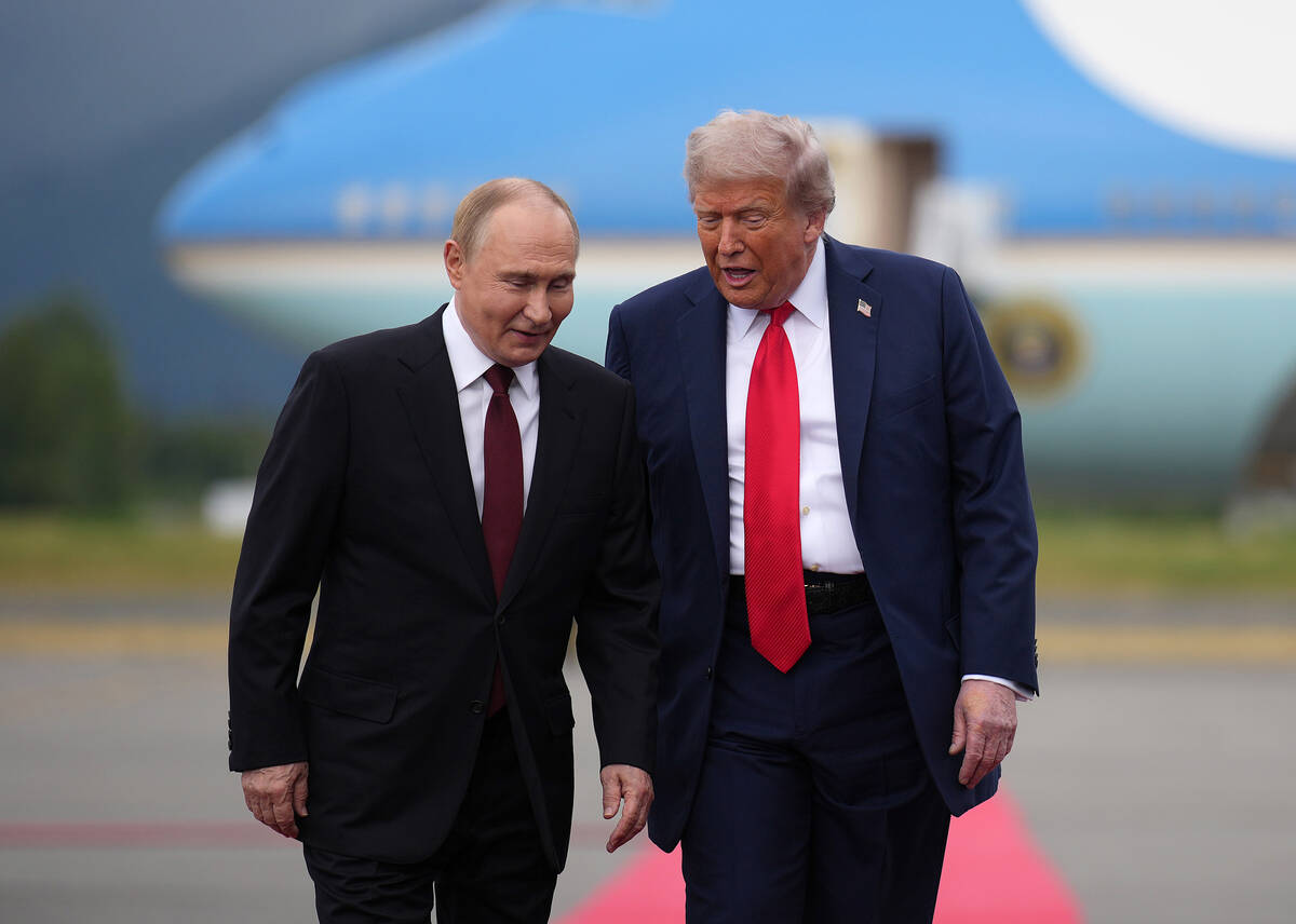 U.S. President Donald Trump, right, walks with Russian President Vladimir Putin as they arrive ...