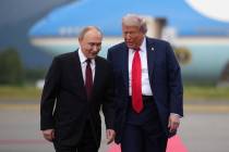 U.S. President Donald Trump, right, walks with Russian President Vladimir Putin as they arrive ...