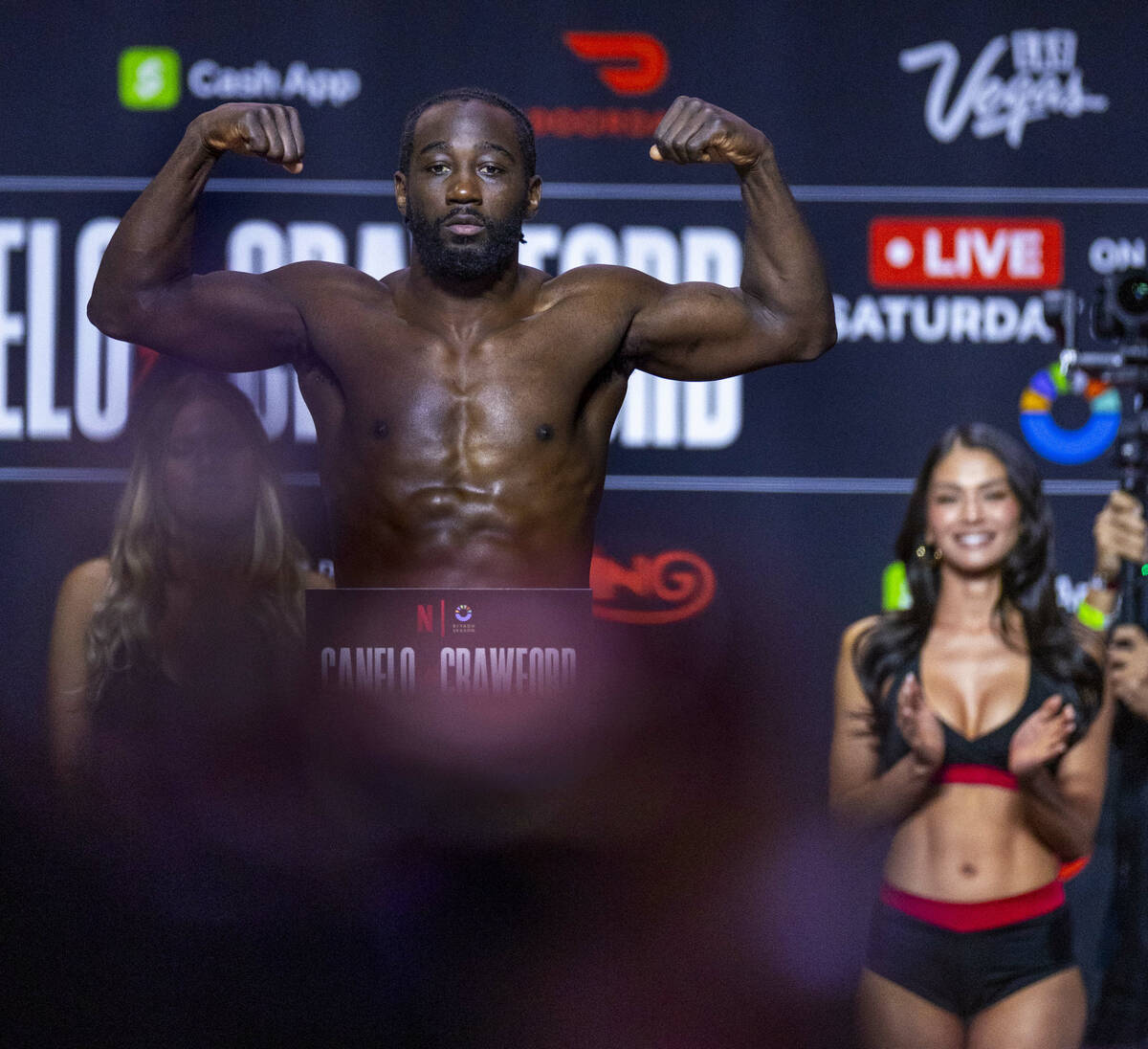 Super Middleweight Championship fighter Terence Crawford flexes on the scale for the crowd duri ...