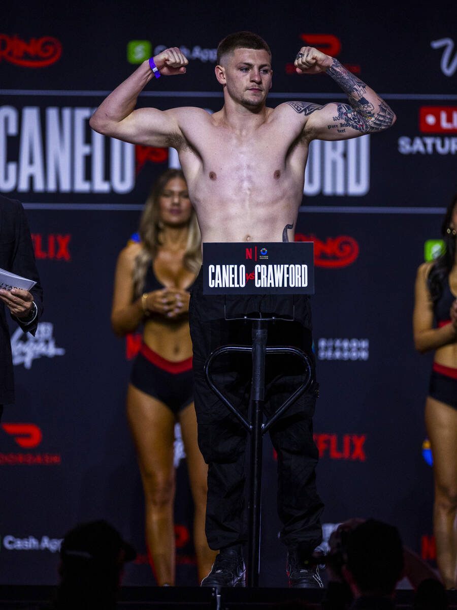 Middleweight fighter Callum Walsh flexes for the crowd during weigh ins for his fight against F ...