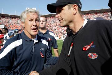 Seattle Seahawks coach Pete Carroll, left, shakes hands with San Francisco 49ers coach Jim Harb ...