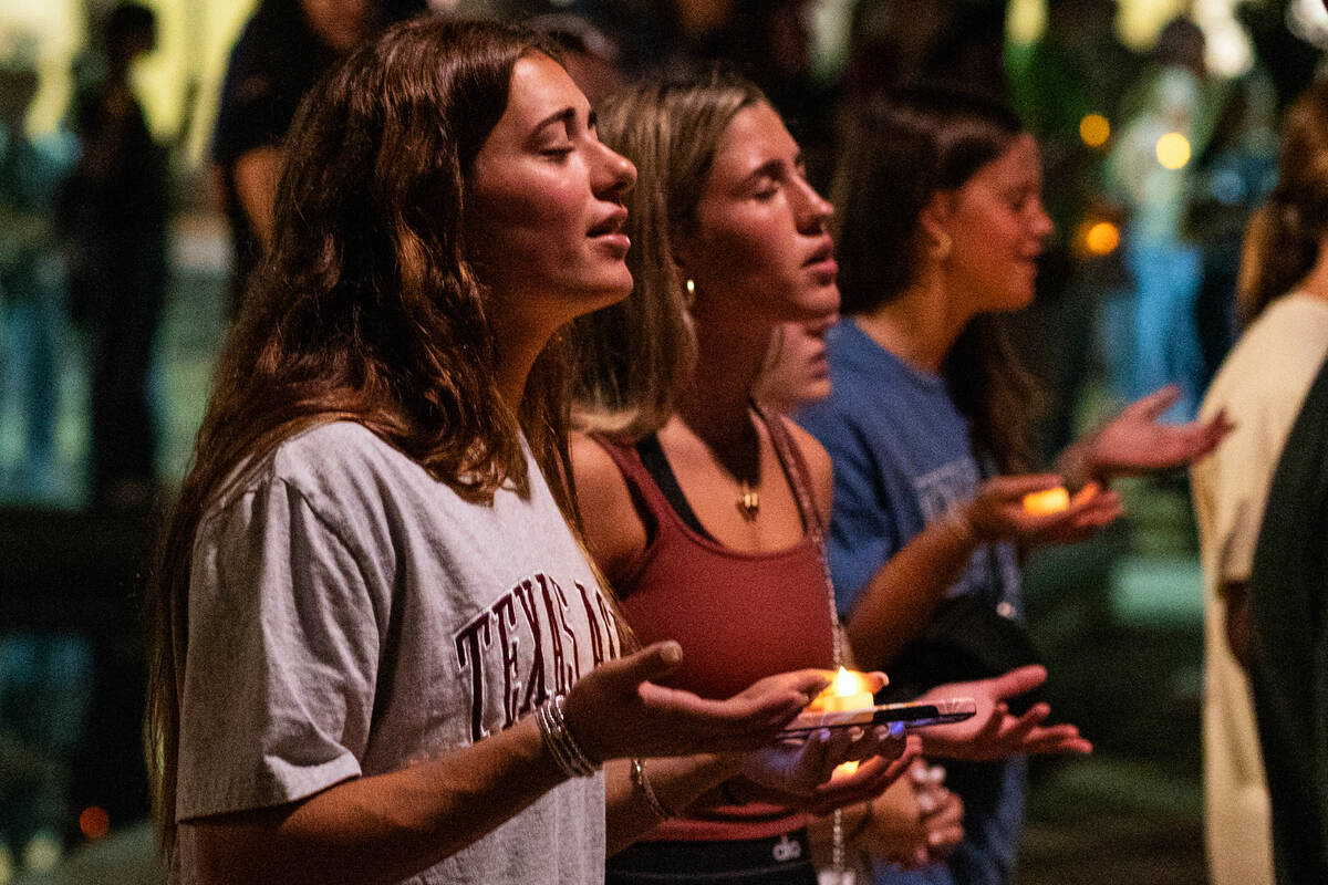 Attendees sing during the worship portion of the vigil for Charlie Kirk at Rudder Plaza on the ...