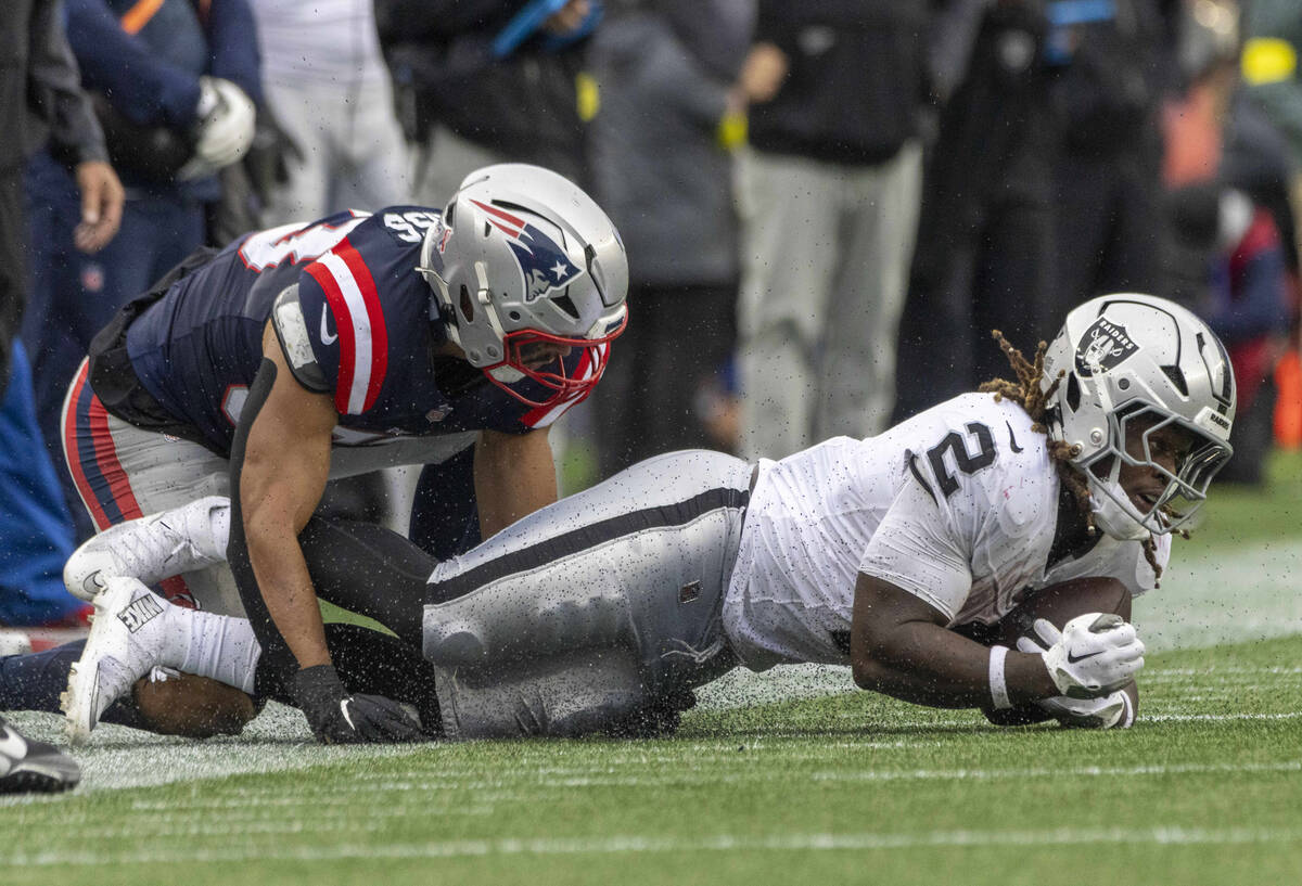 Raiders running back Ashton Jeanty (2) is tackled by New England Patriots linebacker Christian ...