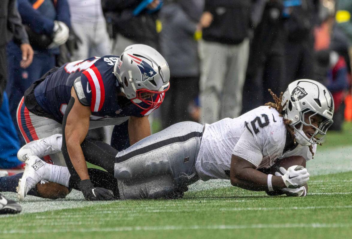 Raiders running back Ashton Jeanty (2) is tackled by New England Patriots linebacker Christian ...