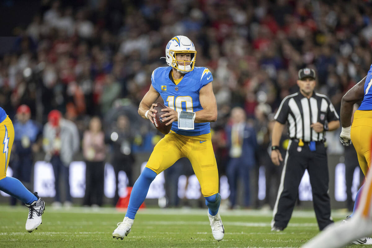 Los Angeles Chargers quarterback Justin Herbert (10) scrambles against the Kansas City Chiefs i ...