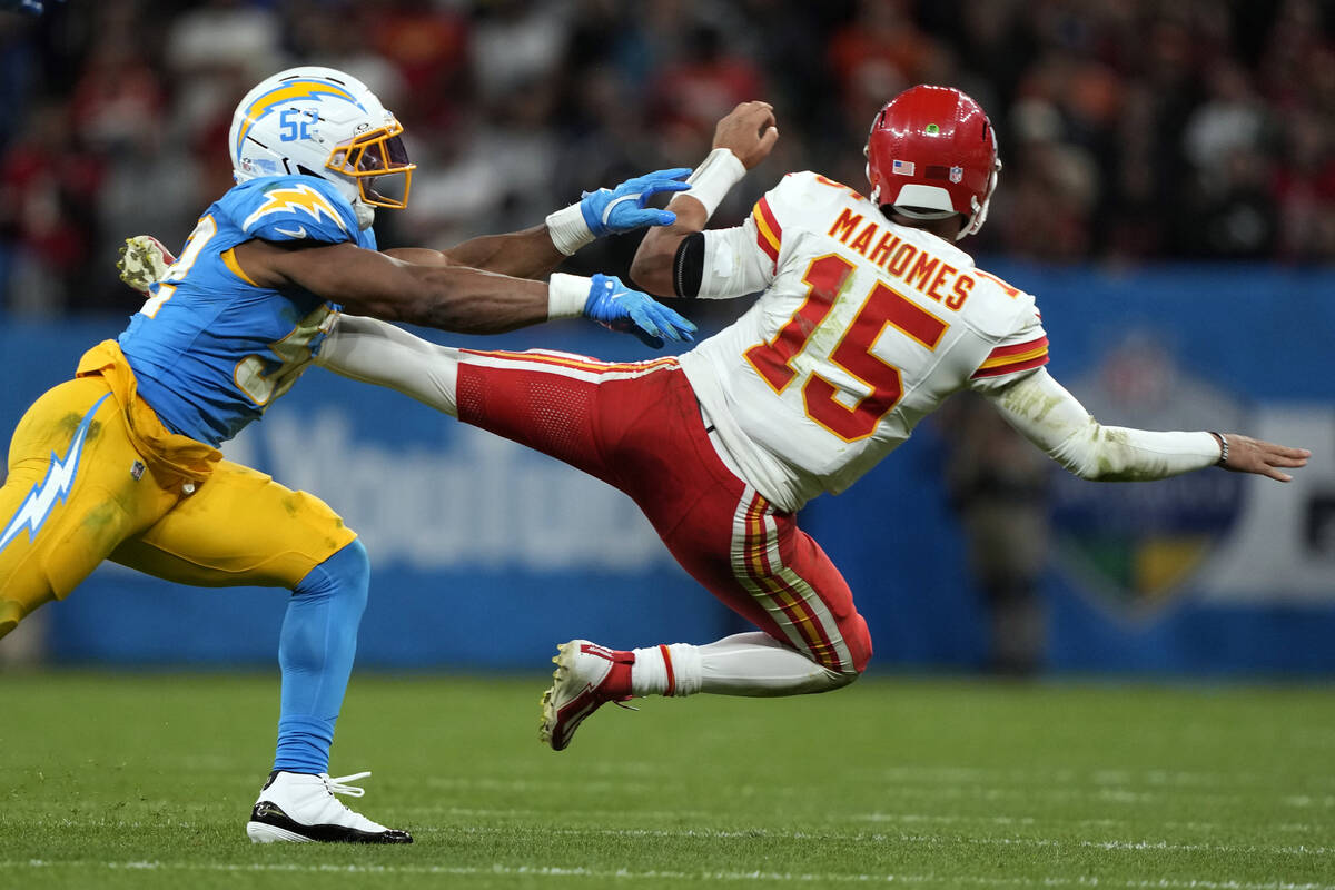 Los Angeles Chargers linebacker Khalil Mack (52) knocks down Kansas City Chiefs quarterback Pat ...