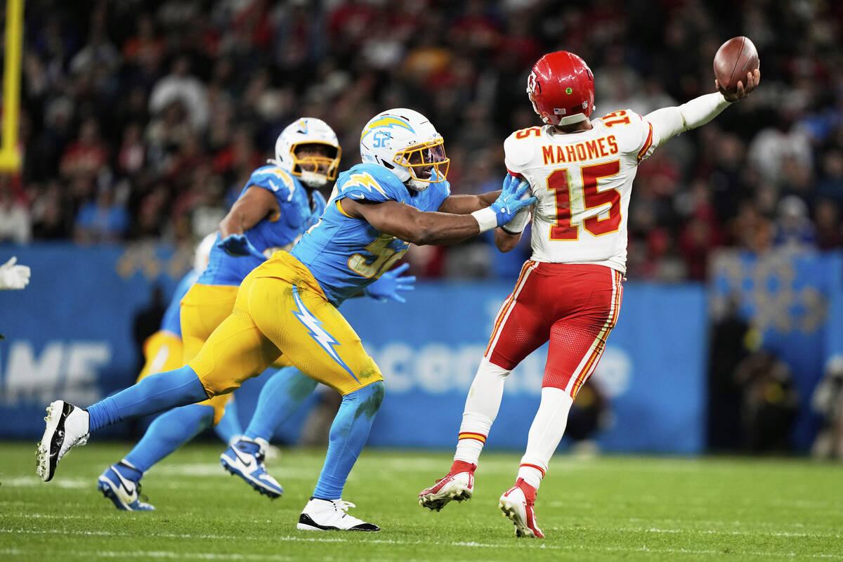 Kansas City Chiefs quarterback Patrick Mahomes passes under pressure from Los Angeles Chargers ...