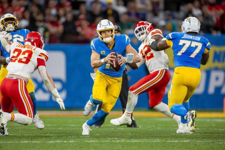 Los Angeles Chargers quarterback Justin Herbert (10) scrambles against the Kansas City Chiefs i ...