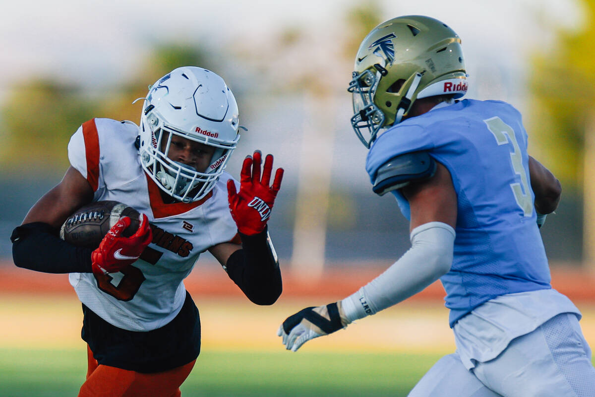 Legacy running abck Zaione Henderson (5) stiff arms Foothill linebacker Taevin Phillips during ...
