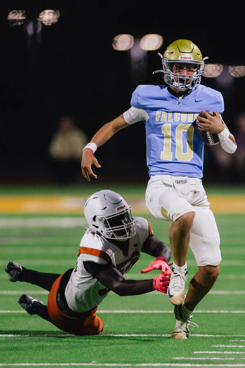 Foothill quarterback Ryder Dobbs escapes a defender as he scrambles during a football game betw ...