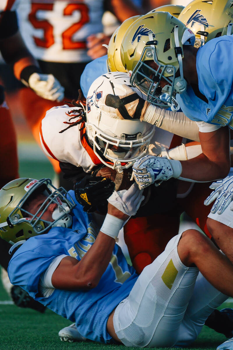 Players scramble for possession of the ball during a football game between Foothill and Legacy ...