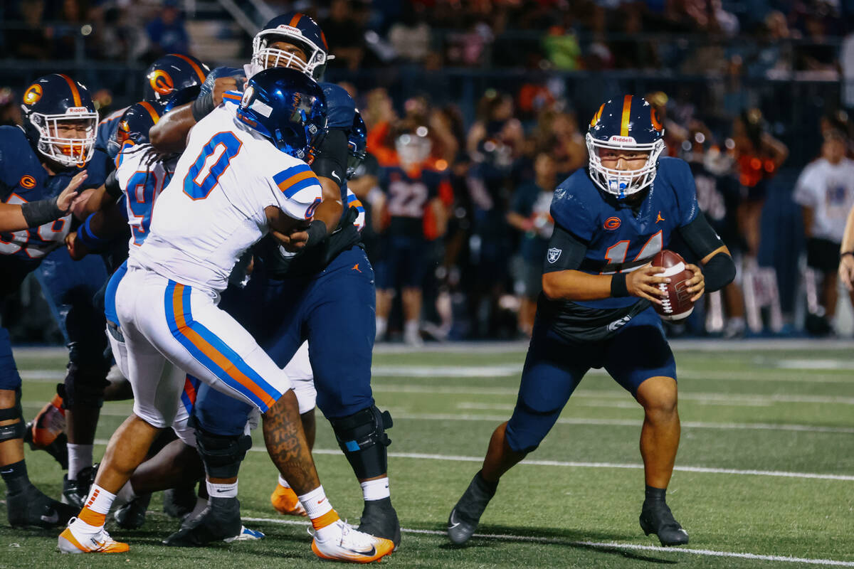 Bishop Gorman quarterback Maika Eugenio (14) runs with the ball during the football game on Fri ...
