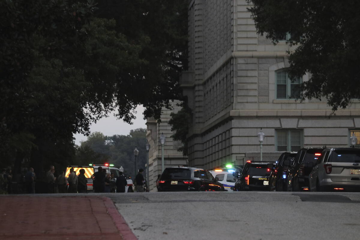 Law enforcement officers gather on the grounds of the U.S. Naval Academy in Annapolis, Md., Thu ...