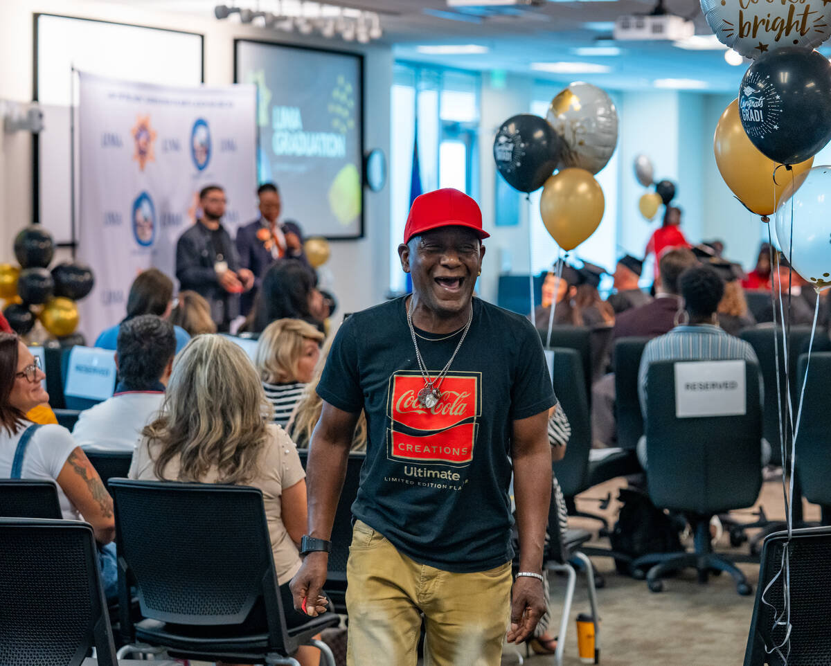 Recovering addict and LIMA community member Deleon Jones walks up to claim his raffle prize dur ...