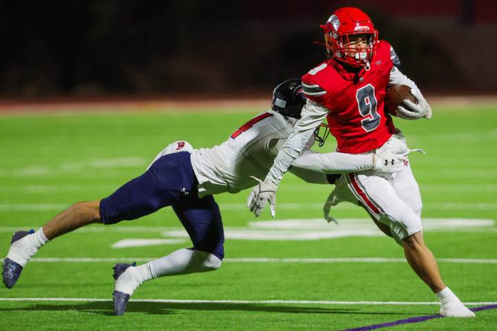 Arbor View wide receiver Kai Cypher (9) runs the ball as Coronado free safety Jackson Humphrie ...