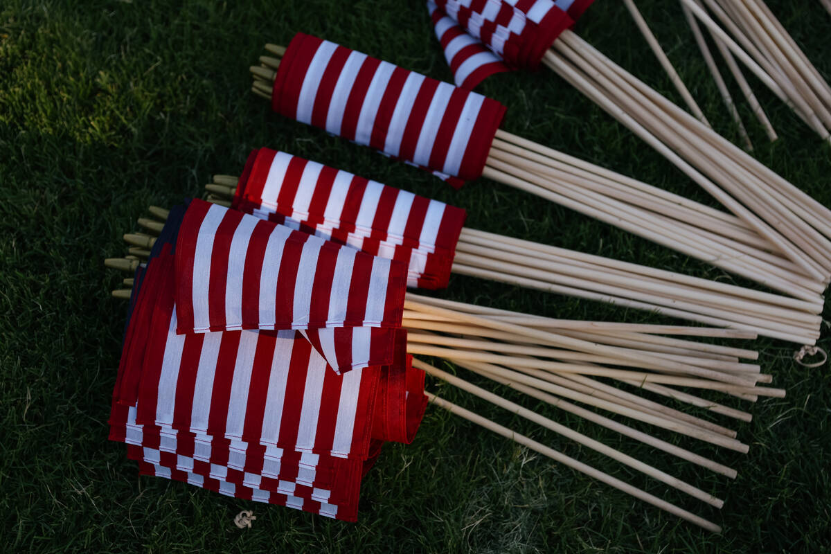 American flags wait to be planted in the ground during an event held in Floyd Lamb Park on Satu ...