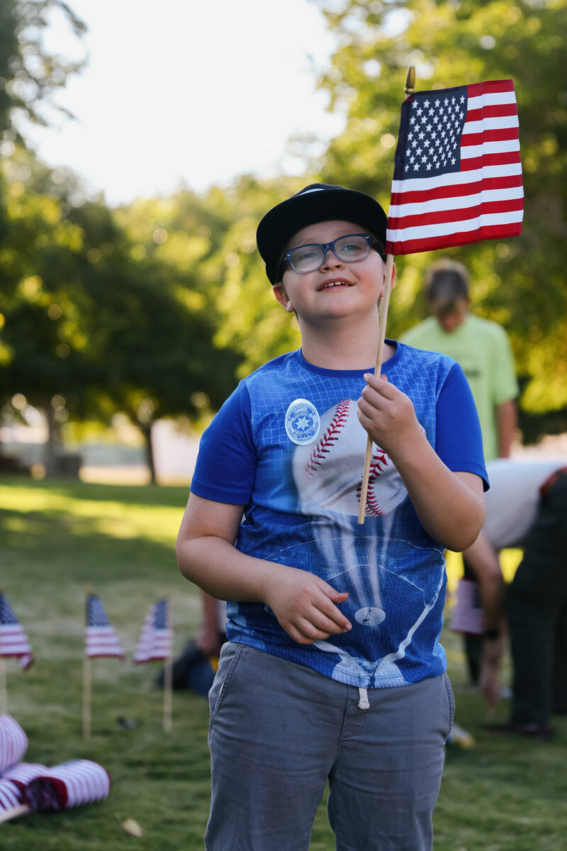 Connor Porterfield, 8, holds an American flag to be planted during an event held in remembrance ...