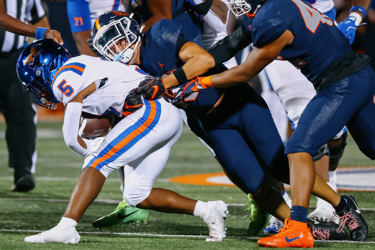 Bishop Gorman defensive back Darian Abella (13) tackles East St. Louis (5) during the football ...