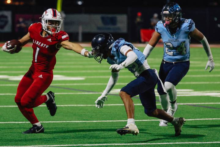 Liberty running back Ezra Sanelivi passes his opponents during a high school football game betw ...