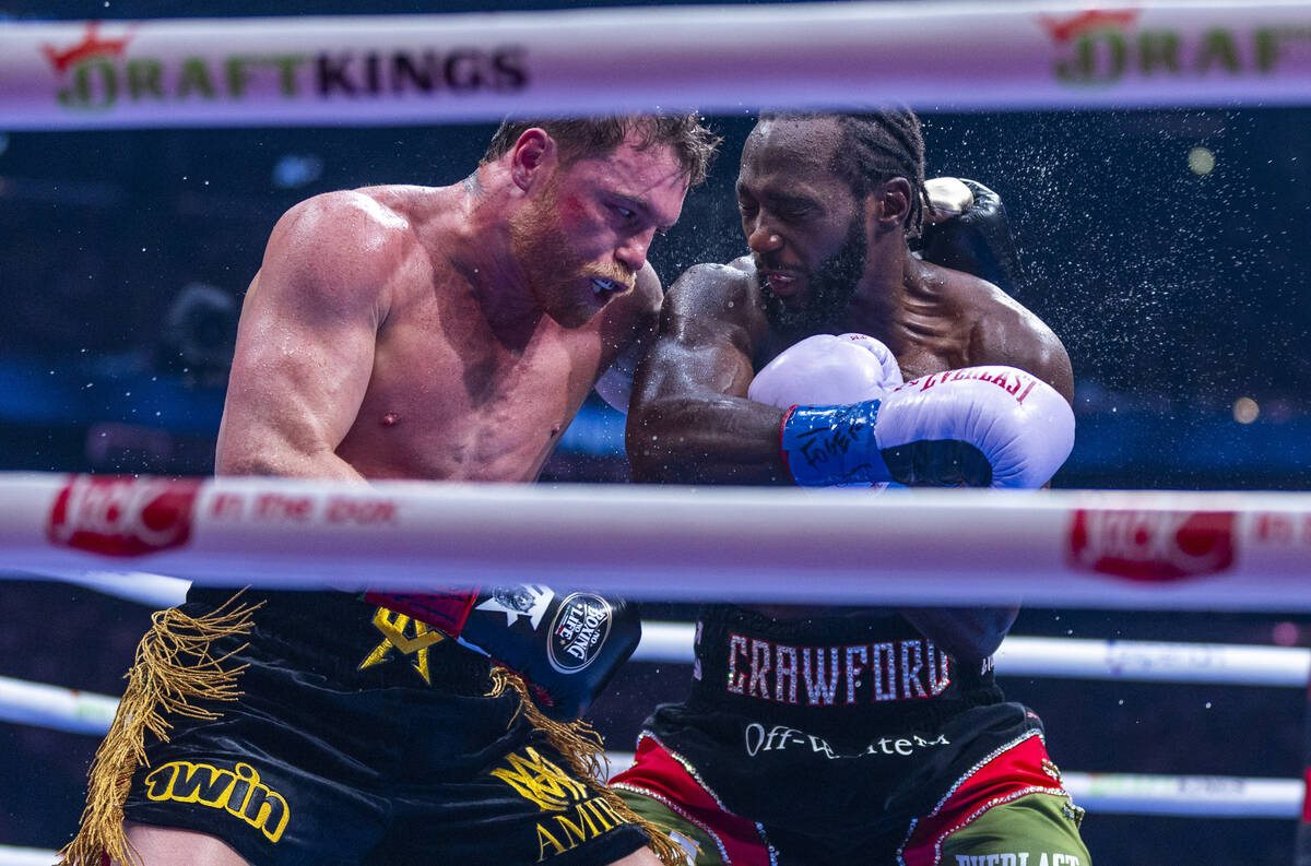 Canelo Alvarez and Terence Crawford battle in the ring during their undisputed super middleweig ...