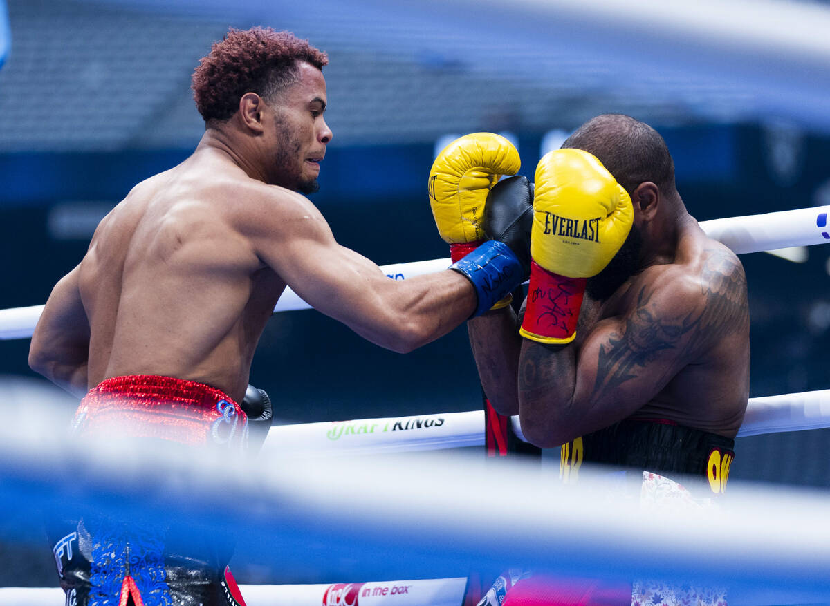 Raiko Santana sneaks in a strike from Steven Nelson in the first round during their super middl ...
