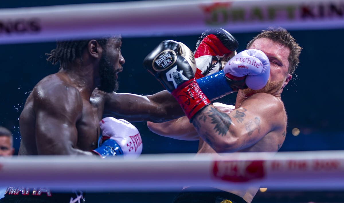 Terence Crawford connects with a punch to the face of Canelo Alvarez during their undisputed su ...