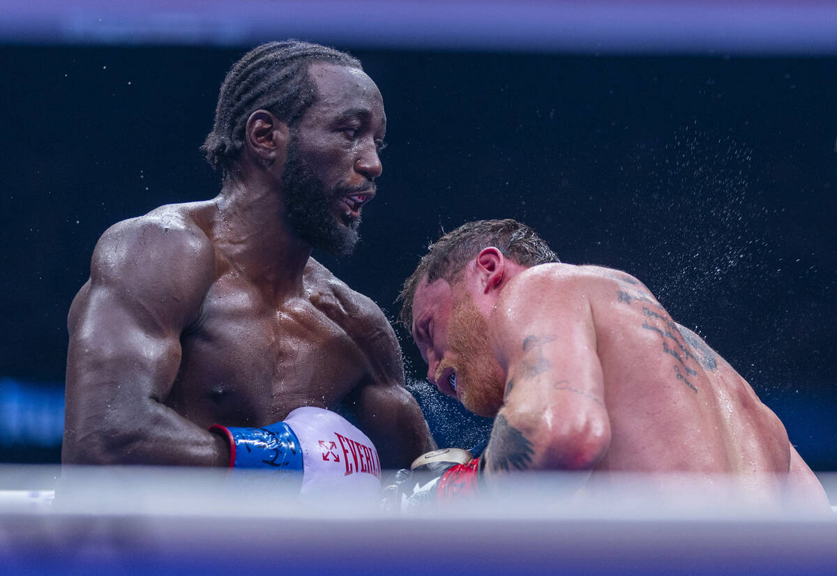 Terence Crawford connects with a punch to the chest of Canelo Alvarez during their undisputed s ...